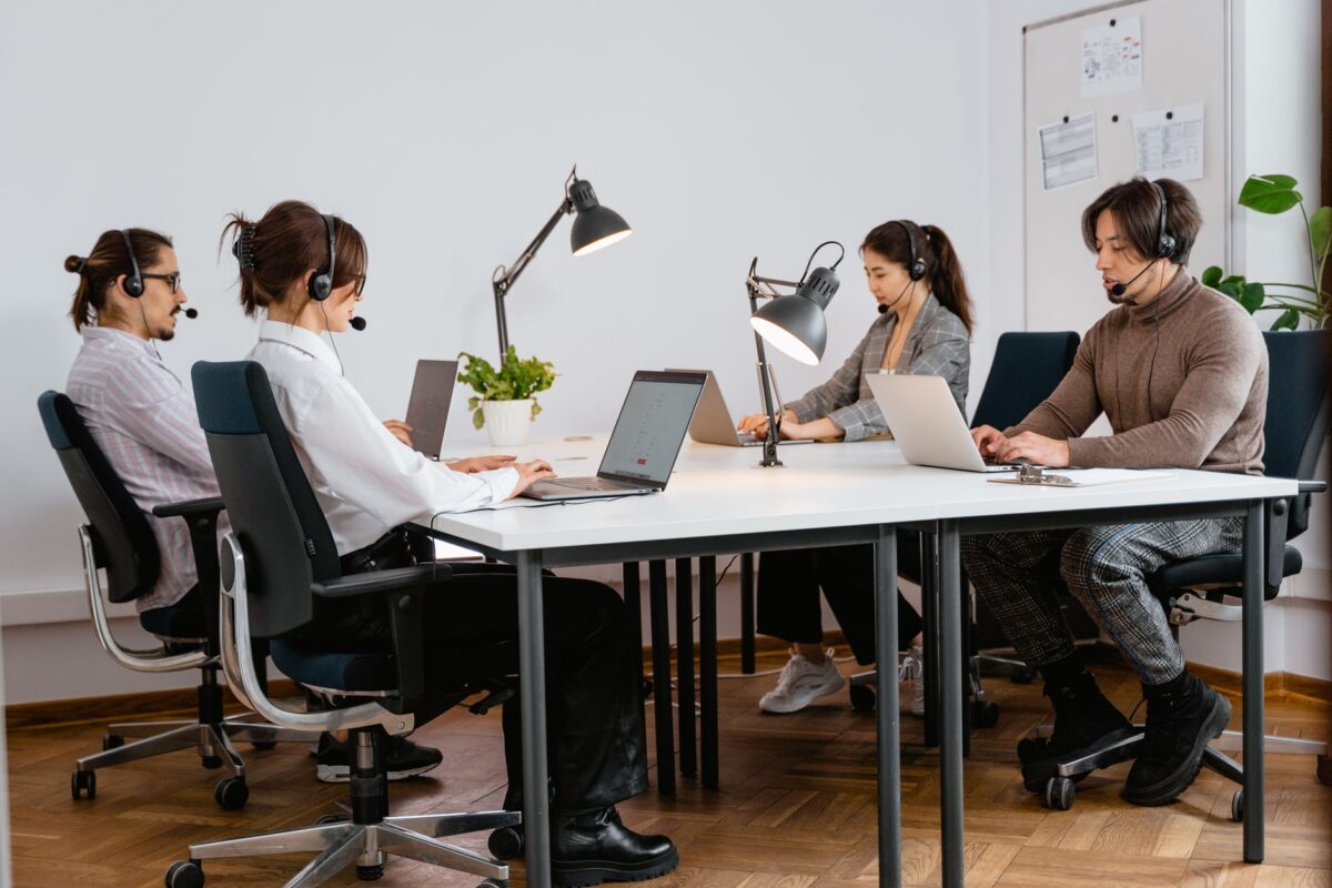 Team of diverse call center agents working diligently in a modern office setting.